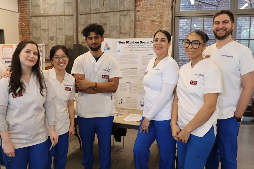 Nursing students gather for poster research presentations.